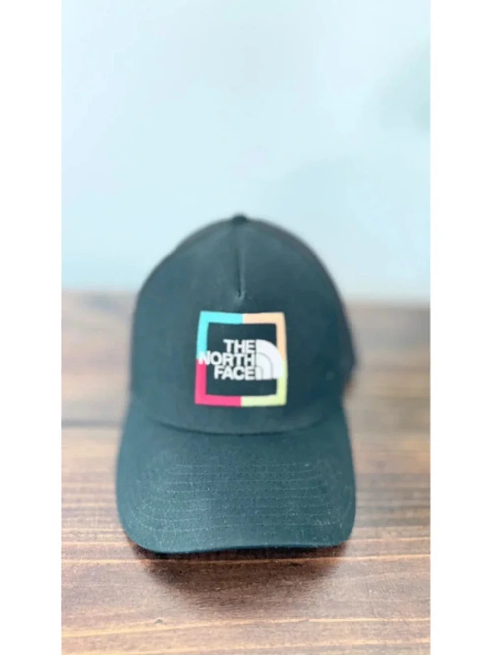 The north face trucker hat black with colorful logo
